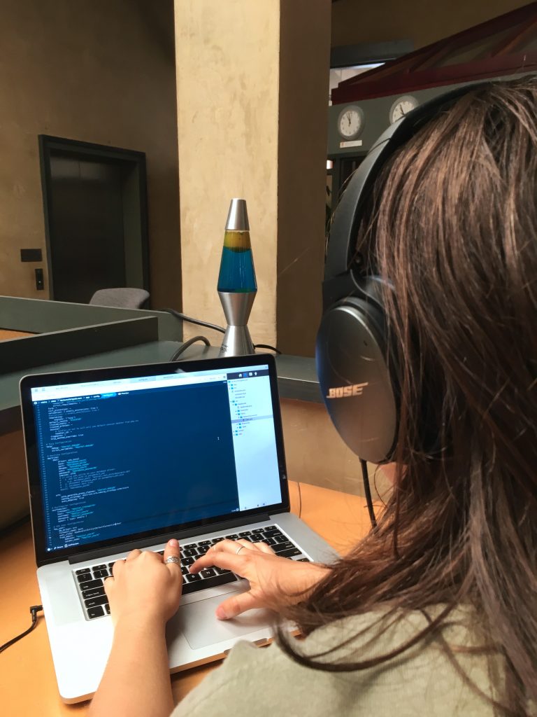 Misha Launch Brigade intern coding on laptop